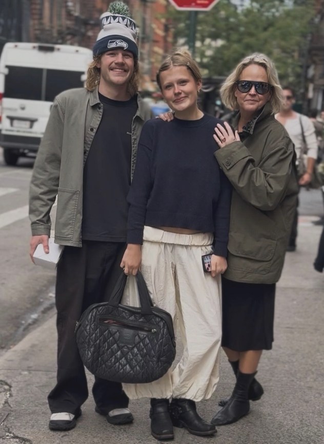 Tiffany and two friends on a city sidewalk in olive, cream and black outfits