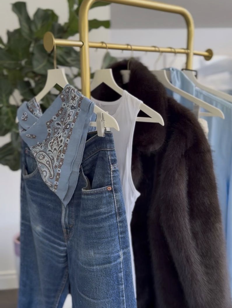 Closet rack with a paisley scarf on jeans, a white tank and a fur coat